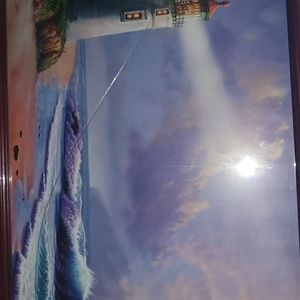 Lighthouse by the beach painting